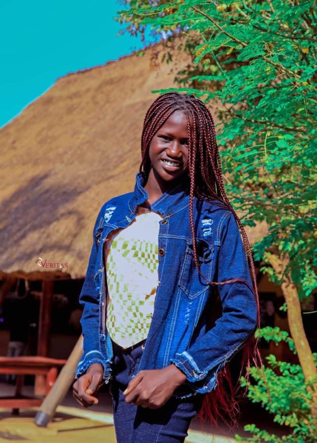 Comedia n Kiden smiling in a green environment in south sudan
