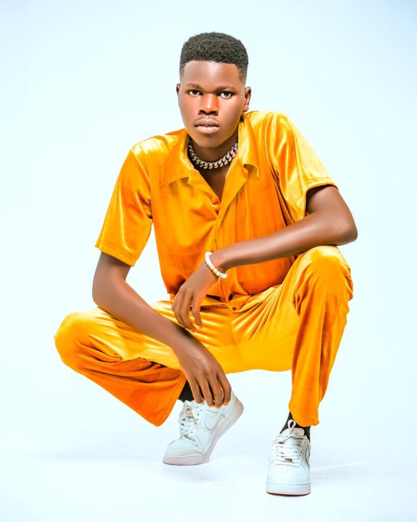 Allan Kato in orange outfit