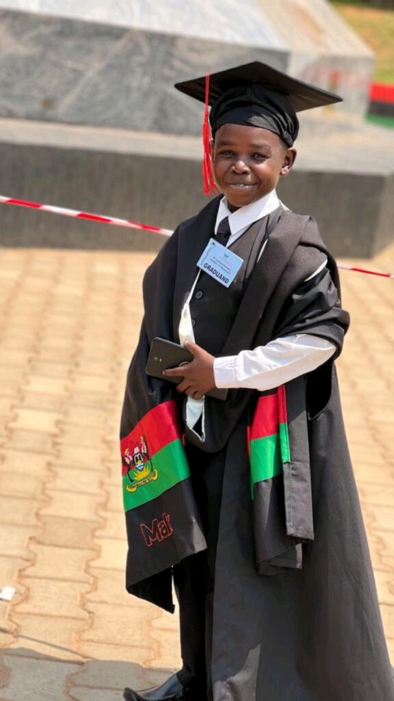 Wasswa Mubarak smiling during graduation at Makerere in a gown
