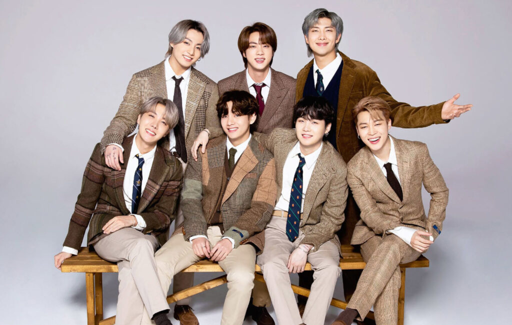 BTS Members pose for a picture in brown suits