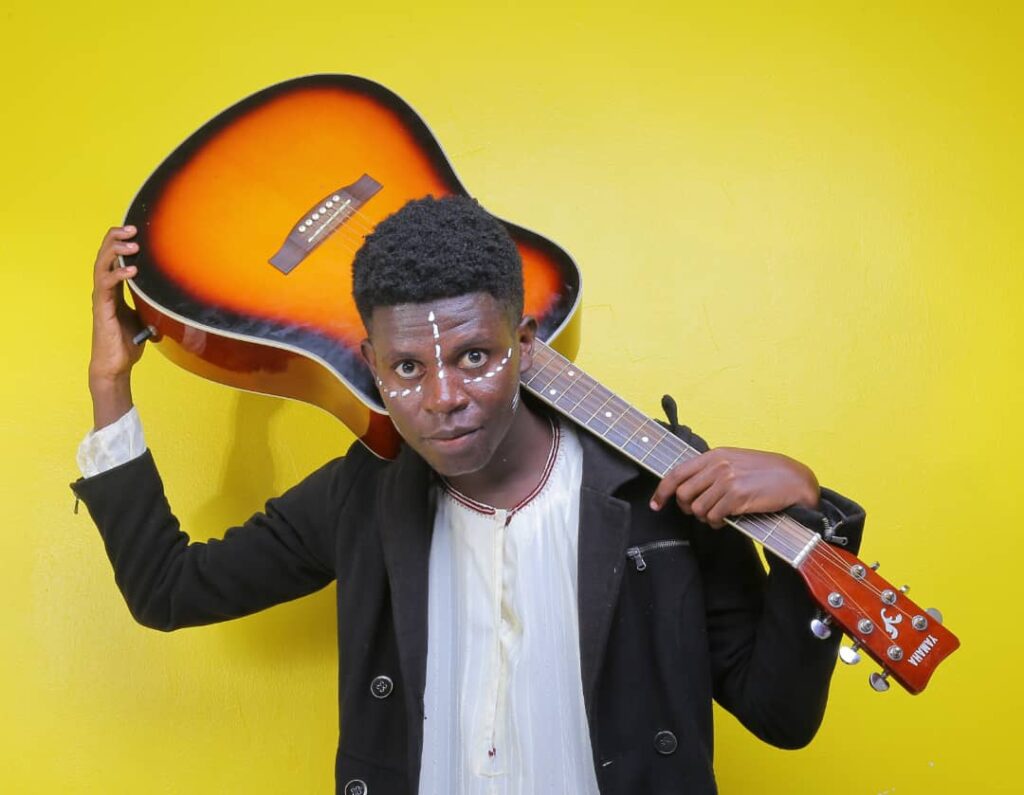 Bogere Farish with guitar on yellow background