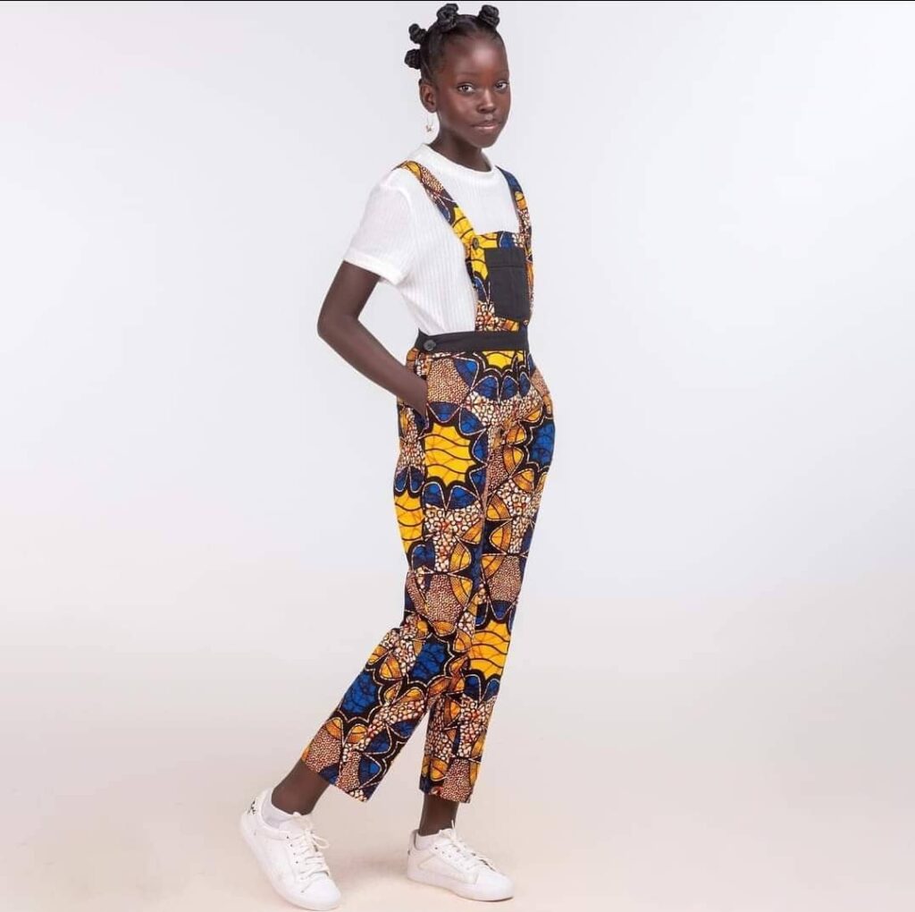Mugasa Myra | Unravelling The Dazzling Ugandan Kid Model 12 kitengi overall for girls. pretty black girl