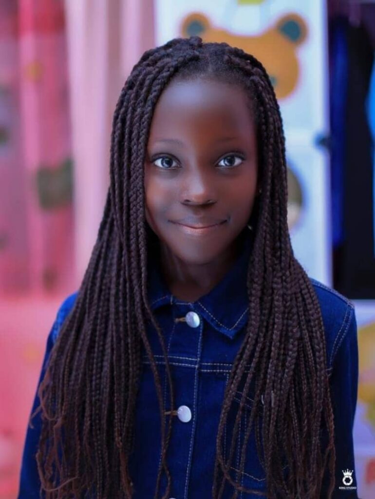 Mugasa Myra | Unravelling The Dazzling Ugandan Kid Model 10 black pretty little girl smiling wearing jean shirt with tall hair