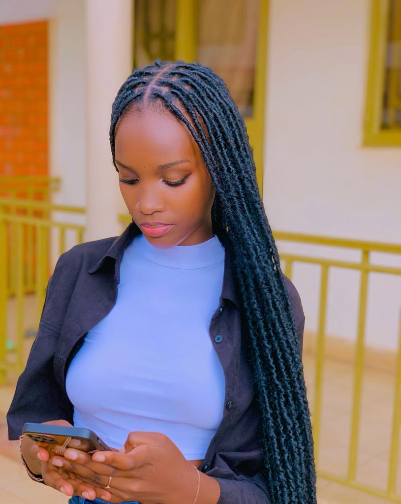 Sharon Kiyimba Promise, Winner of Top Model Uganda 2023. 6 beautiful african girl typing on her phone