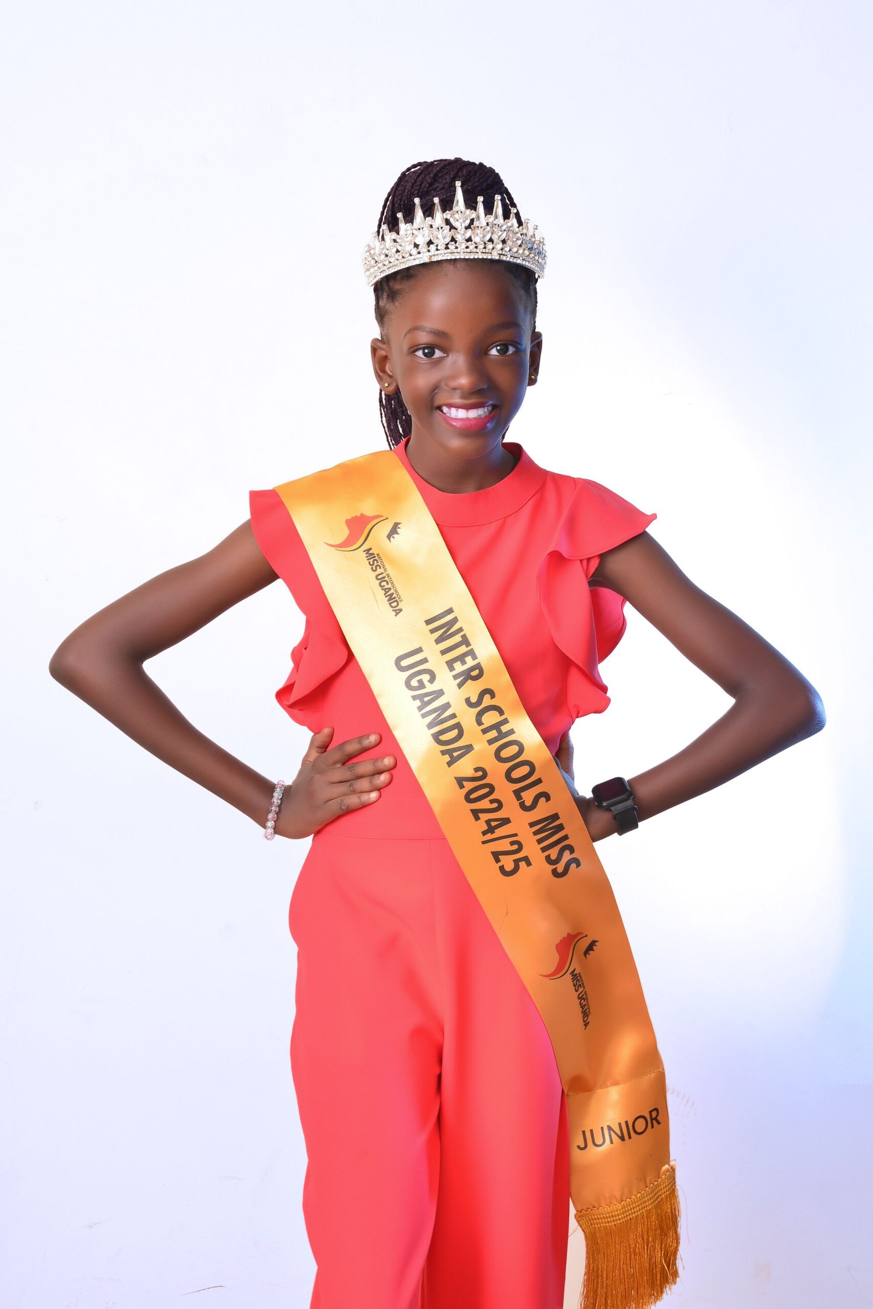 Little Ugandan girl wearing sash for inter-schools miss Uganda