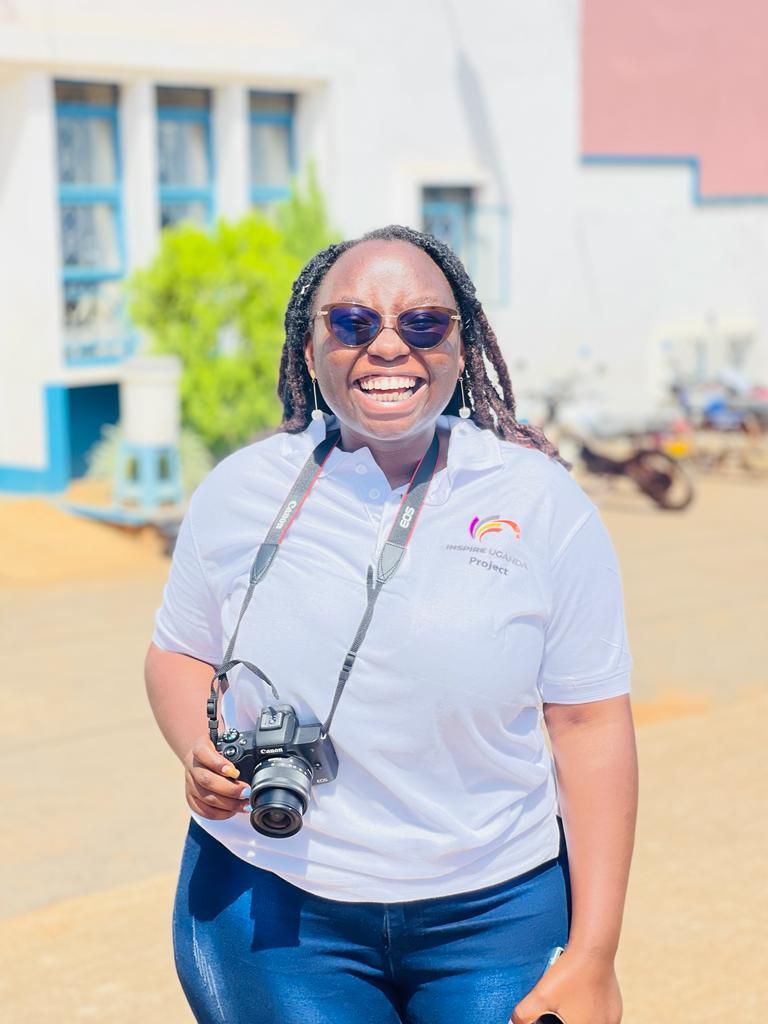 Hannah smiling while holding a camera