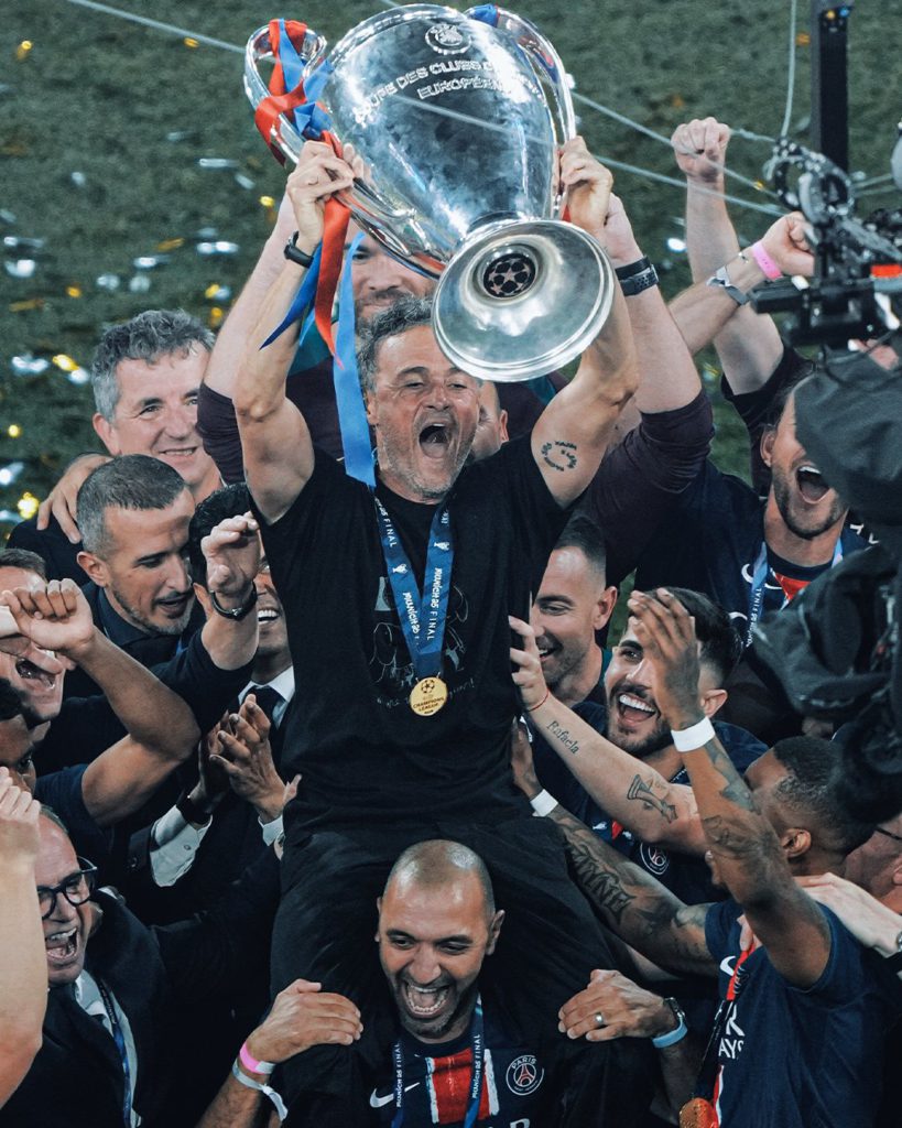 PSG head coach Luis Enrique lifted by players as they celebrate the win